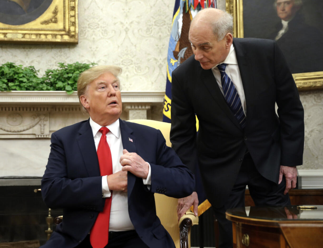 FILE - White House Chief of Staff John Kelly, right, leans in to talk with President Donald Trump in the Oval Office of the White House in Washington, June 27, 2018.