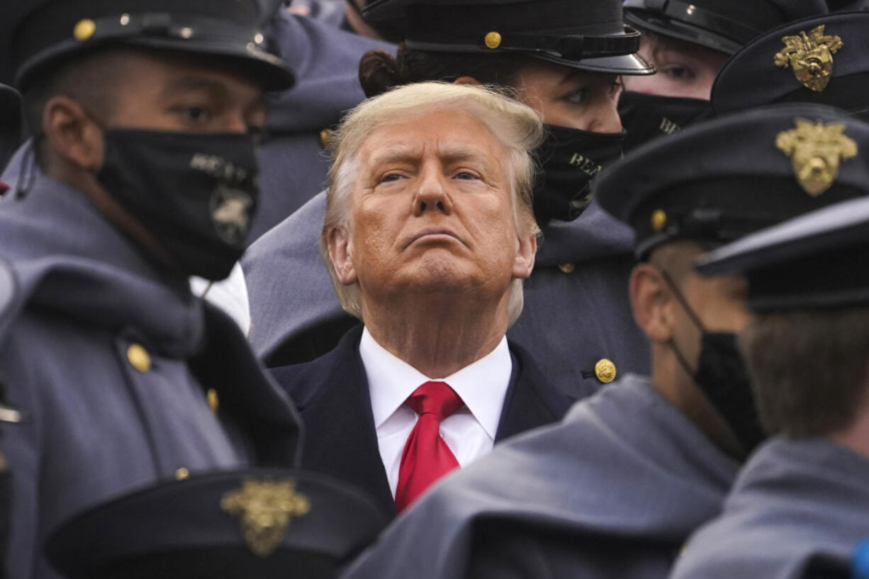 FILE - Surrounded by Army cadets, President Donald Trump watches the first half of the 121st Army-Navy Football Game, Dec. 12, 2020, in West Point, N.Y.