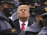 FILE - Surrounded by Army cadets, President Donald Trump watches the first half of the 121st Army-Navy Football Game, Dec. 12, 2020, in West Point, N.Y.