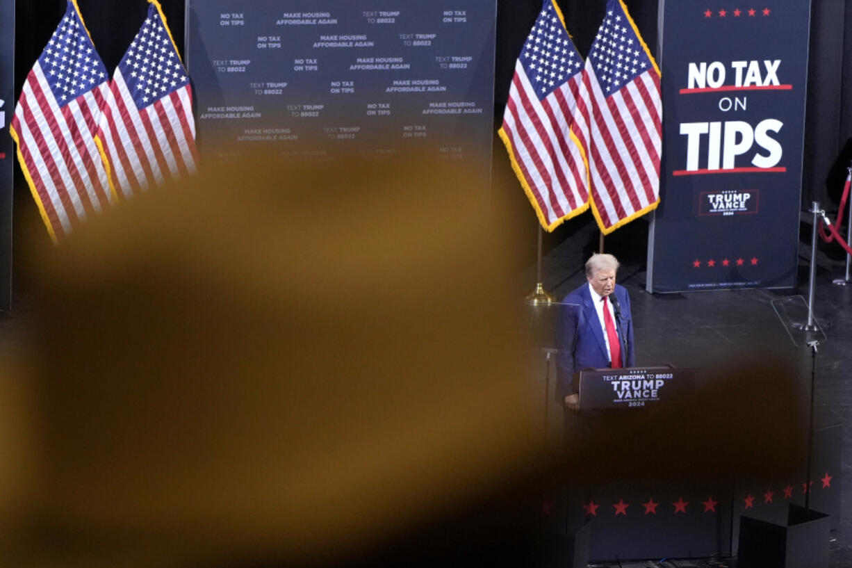 FILE - A supporter listens as Republican presidential nominee former President Donald Trump speaks during a campaign event, Sept.12, 2024, in Tucson, Ariz.