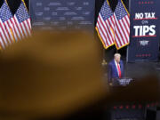 FILE - A supporter listens as Republican presidential nominee former President Donald Trump speaks during a campaign event, Sept.12, 2024, in Tucson, Ariz.