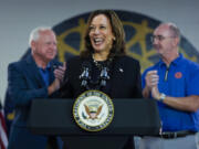 FILE - Democratic presidential nominee Vice President Kamala Harris, with Democratic vice presidential nominee Minnesota Gov. Tim Walz, left, and UAW President Shawn Fain, speaks at a campaign rally at UAW Local 900, Aug. 8, 2024, in Wayne, Mich.