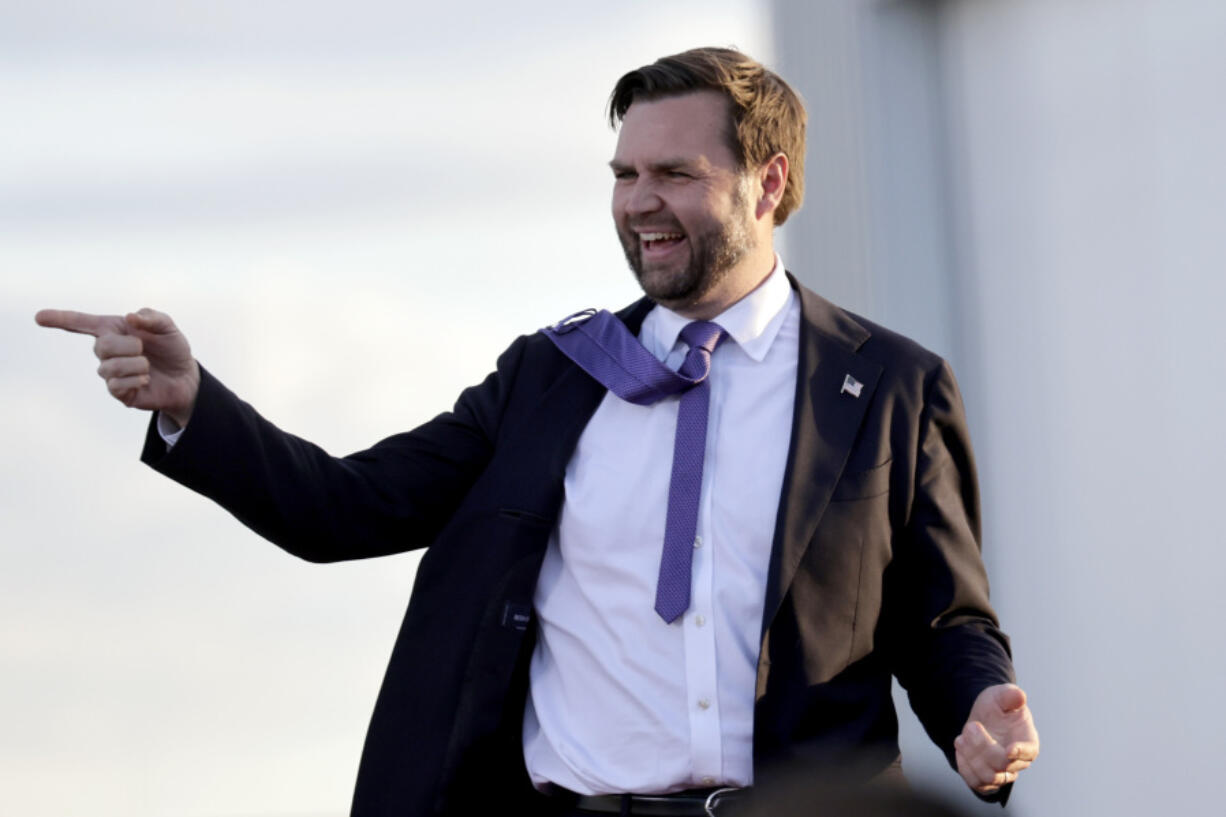 Republican vice presidential nominee Sen. JD Vance, R-Ohio, greets the crowd as he arrives to speak at a campaign rally at Wilmington International Airport, Wednesday, Oct. 16, 2024, in Wilmington, N.C.