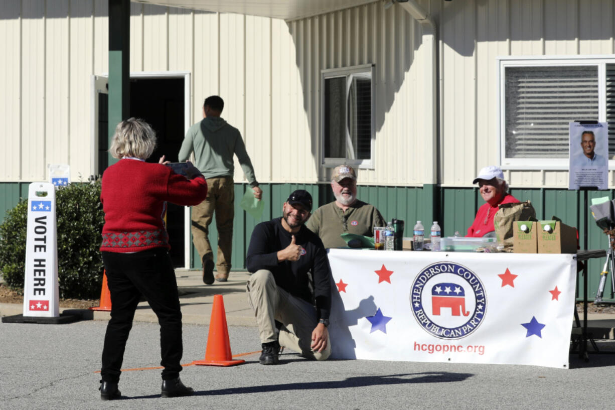 Francisco Gonzalez poses for a picture at the Henderson County Republican Party table after voting for Donald Trump at the Henderson County Board of Elections on the first day of early voting in the state, Thursday, Oct. 17, 2024, in Hendersonville, N.C.