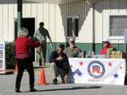 Francisco Gonzalez poses for a picture at the Henderson County Republican Party table after voting for Donald Trump at the Henderson County Board of Elections on the first day of early voting in the state, Thursday, Oct. 17, 2024, in Hendersonville, N.C.