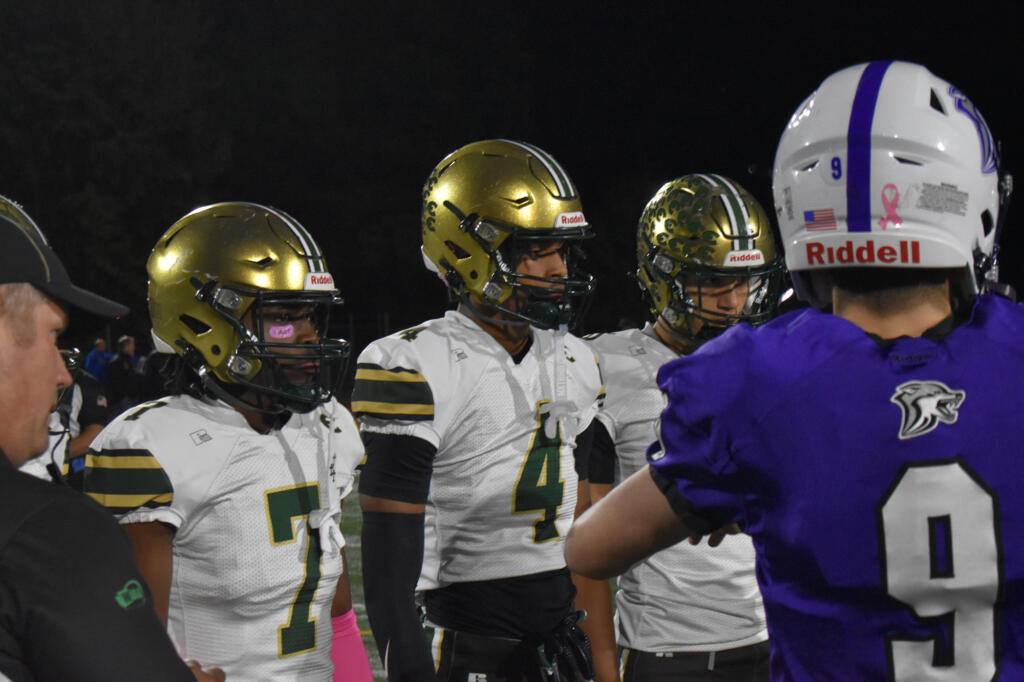 Thaddeus Pruitt (7) and Ryder Keplar (4) of Evergreen watch the opening coin toss against Heritage before a 3A Greater St. Helens League football game at McKenzie Stadium on Friday, Oct. 25, 2024.