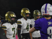 Thaddeus Pruitt (7) and Ryder Keplar (4) of Evergreen watch the opening coin toss against Heritage before a 3A Greater St. Helens League football game at McKenzie Stadium on Friday, Oct. 25, 2024.