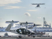 FILE - An electric vertical takeoff and landing (eVTOL) aircraft, flies above the Joby eVTOL aircraft, during a demonstration of eVTOLs Nov. 13, 2023, in New York.