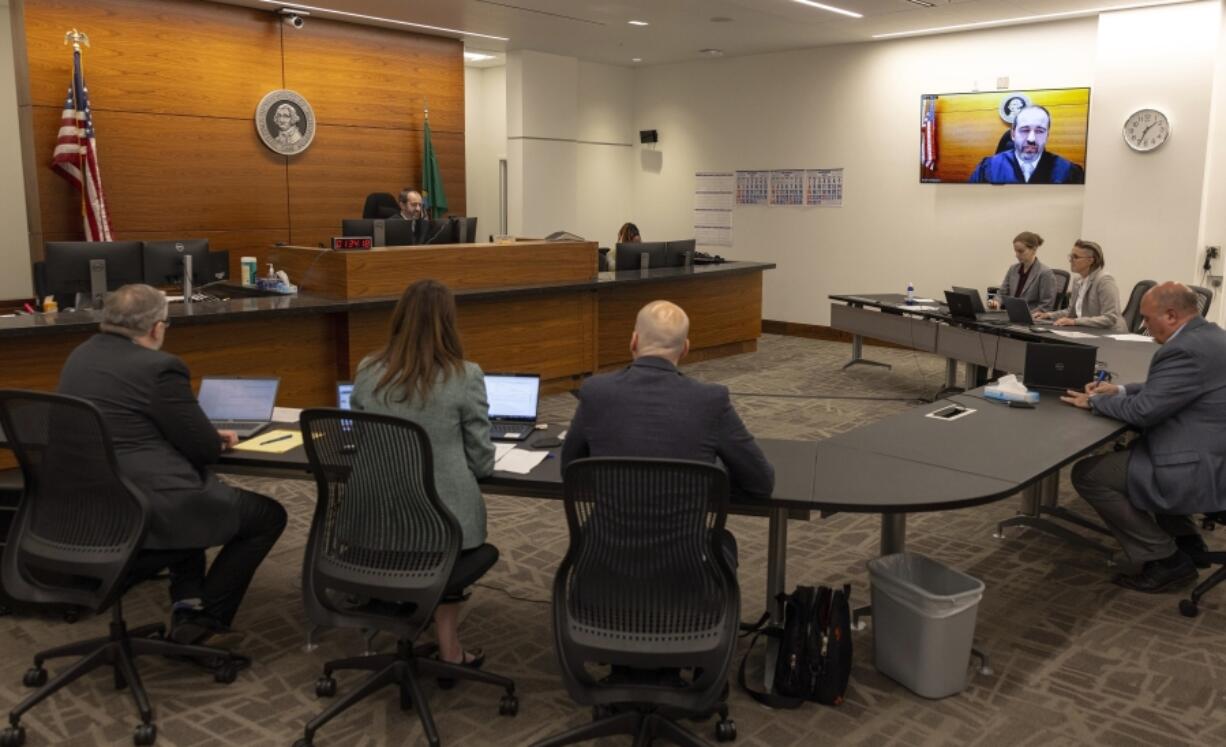 King County Superior Court Judge Joe Campagna, top left, speaks during a preliminary hearing for a suspect in the shooting deaths of five people at a home in Fall City, at the Clark Child and Family Justice Center, Tuesday, Oct. 22, 2024, in Seattle.