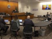 King County Superior Court Judge Joe Campagna, top left, speaks during a preliminary hearing for a suspect in the shooting deaths of five people at a home in Fall City, at the Clark Child and Family Justice Center, Tuesday, Oct. 22, 2024, in Seattle.