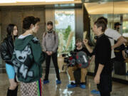 Mikey Madison, left, and Mark Eydelshteyn, second left, with director Sean Baker, right, on the set of  &ldquo;Anora.&rdquo; (Augusta Quirk/Neon)