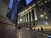 People pass the New York Stock Exchange early Tuesday, Oct. 29, 2024.