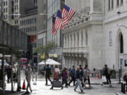 FILE - People pass the New York Stock Exchange on Oct. 1, 2024, in New York.