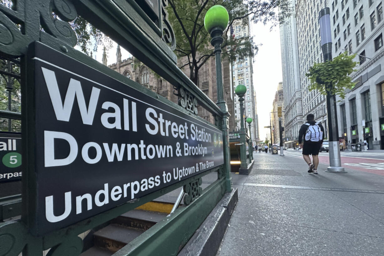 FILE - People pass the entrance for the Wall Street subway station on Sept. 2, 2024, in New York.