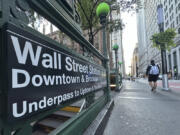 FILE - People pass the entrance for the Wall Street subway station on Sept. 2, 2024, in New York.