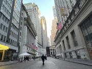 FILE - American flags, left, hang from the New York Stock Exchange on Oct. 16, 2024, in New York.