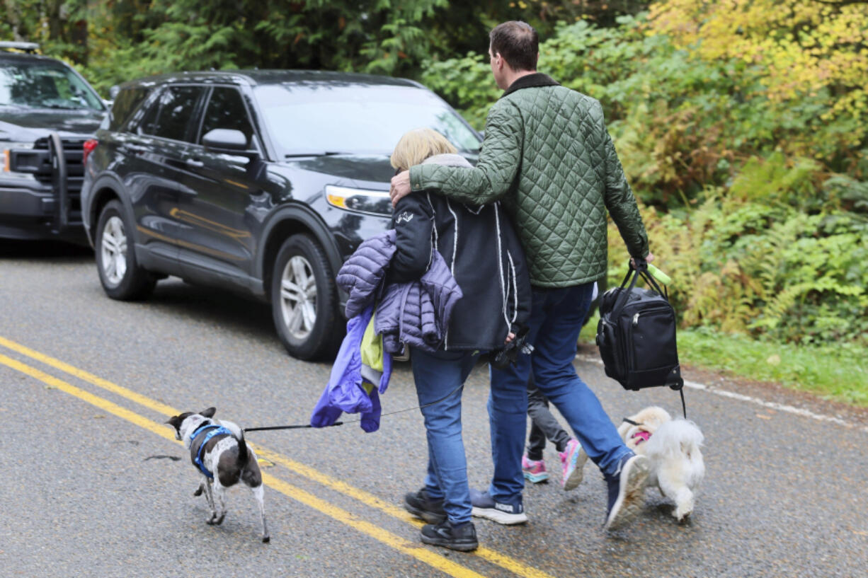 Neighbors leave the scene of a fatal shooting Monday morning, Oct. 21, 2024, in Fall City, Wash.