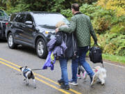 Neighbors leave the scene of a fatal shooting Monday morning, Oct. 21, 2024, in Fall City, Wash.