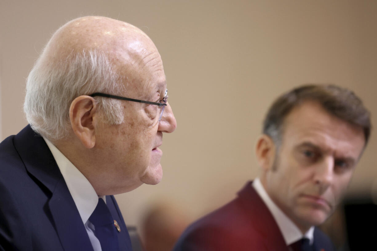 French President Emmanuel Macron listens to Lebanon&rsquo;s Prime Minister caretaker Prime Minister Najib Mikati, left, during international conference for Lebanon in Paris, Thursday, Oct.24, 2024.