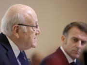 French President Emmanuel Macron listens to Lebanon&rsquo;s Prime Minister caretaker Prime Minister Najib Mikati, left, during international conference for Lebanon in Paris, Thursday, Oct.24, 2024.