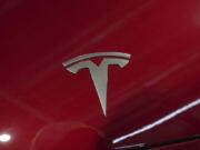 The logo of Tesla car is pictured at the Paris Auto Show, in Paris, Monday, Oct. 14, 2024.