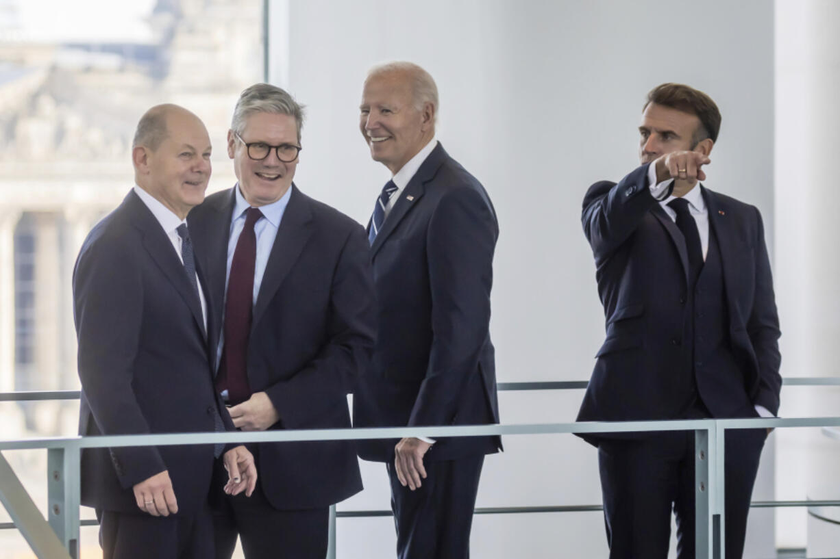 France&rsquo;s President Emmanuel Macron, right, gestures as German Chancellor Olaf Scholz, left, British Prime Minister Keir Starmer, second left, and U.S. President Joe Biden react in the Chancellery in Berlin, Friday Oct. 18, 2024.