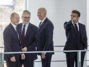 France&rsquo;s President Emmanuel Macron, right, gestures as German Chancellor Olaf Scholz, left, British Prime Minister Keir Starmer, second left, and U.S. President Joe Biden react in the Chancellery in Berlin, Friday Oct. 18, 2024.