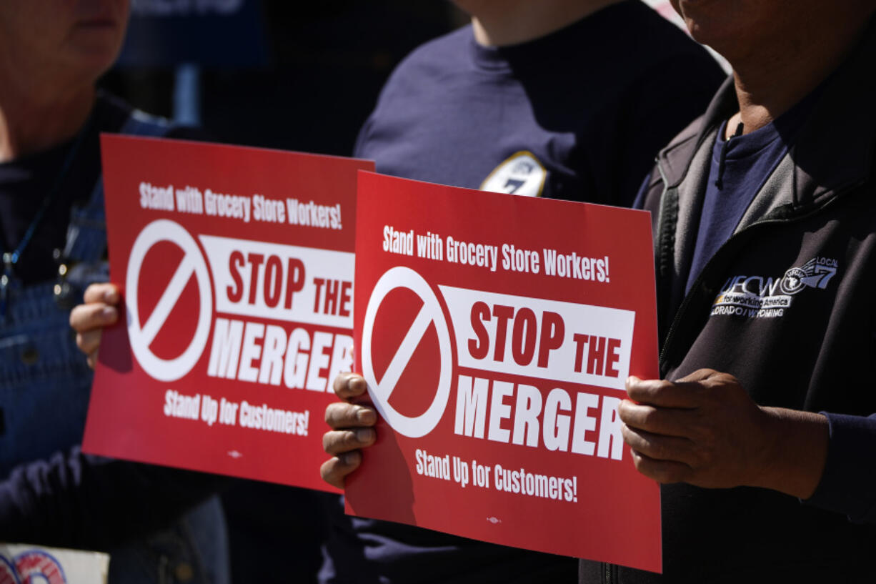 Union members hold placards against the proposed merger of grocery store chains Kroger and Albertsons Monday, Sept. 30, 2024, during a protest outside the City/County Building, while inside the courthouse the Colorado attorney&rsquo;s general office presented its case against the merger in the opening day of the trial in Denver.