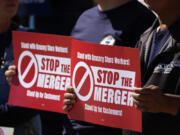 Union members hold placards against the proposed merger of grocery store chains Kroger and Albertsons Monday, Sept. 30, 2024, during a protest outside the City/County Building, while inside the courthouse the Colorado attorney&rsquo;s general office presented its case against the merger in the opening day of the trial in Denver.