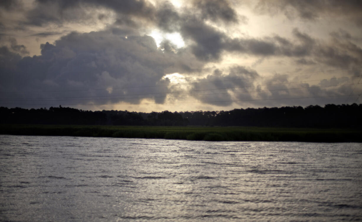 FILE - The sun rises over Sapelo Island, Ga., a Gullah-Geechee community, on June 10, 2013.