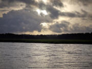 FILE - The sun rises over Sapelo Island, Ga., a Gullah-Geechee community, on June 10, 2013.