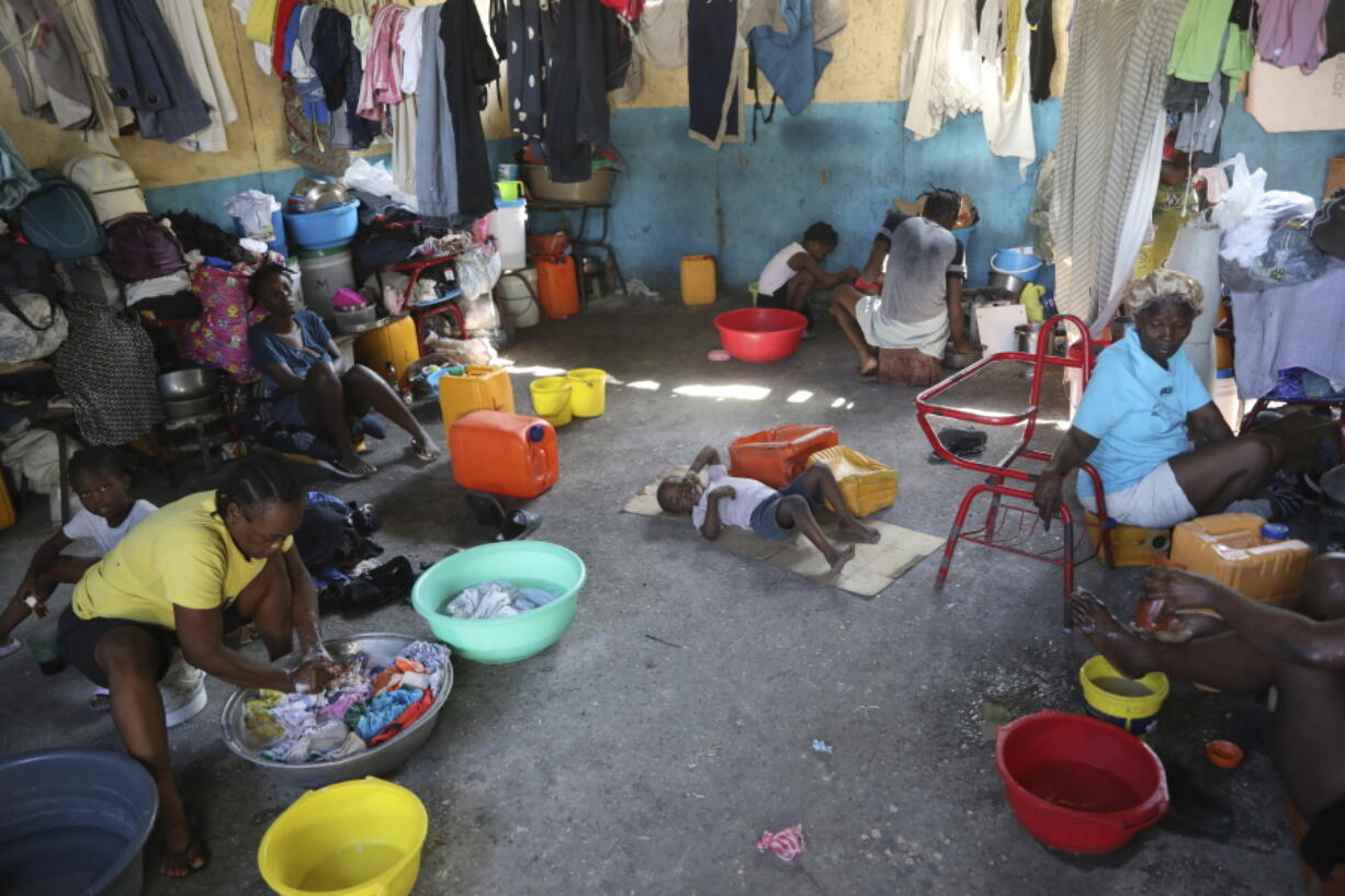 Families displaced by gang violence do laundry inside a school where they have been taking refuge for over a year in Port-au-Prince, Haiti, Friday, Sept. 20, 2024.