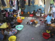 Families displaced by gang violence do laundry inside a school where they have been taking refuge for over a year in Port-au-Prince, Haiti, Friday, Sept. 20, 2024.