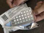 FILE - A one-month dosage of hormonal birth control pills is displayed in Sacramento, Calif., Aug. 26, 2016.