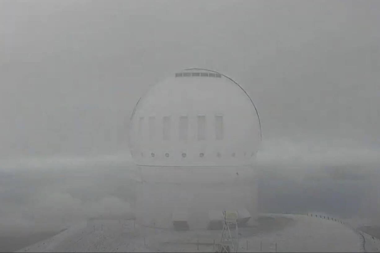 This image made from video provided, shows snow on the summit of Mauna Kea in Hawaii on Sunday.