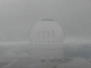 This image made from video provided, shows snow on the summit of Mauna Kea in Hawaii on Sunday.