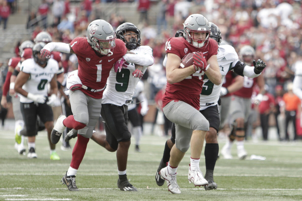 Washington State tight end Cooper Mathers (24) carries the ball as wide receiver Kris Hutson (1) blocks Hawaii defensive back Elijah Palmer (9) during the second half of an NCAA college football game, Saturday, Oct. 19, 2024, in Pullman, Wash.