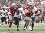 Washington State tight end Cooper Mathers (24) carries the ball as wide receiver Kris Hutson (1) blocks Hawaii defensive back Elijah Palmer (9) during the second half of an NCAA college football game, Saturday, Oct. 19, 2024, in Pullman, Wash.