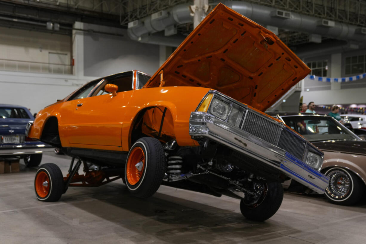 An orange lowrider car is on display at the Slow &amp; Low Chicago Lowrider Festival, Saturday, Oct. 12, 2024, at Navy Pier in Chicago.