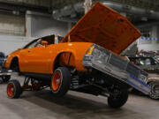 An orange lowrider car is on display at the Slow &amp; Low Chicago Lowrider Festival, Saturday, Oct. 12, 2024, at Navy Pier in Chicago.