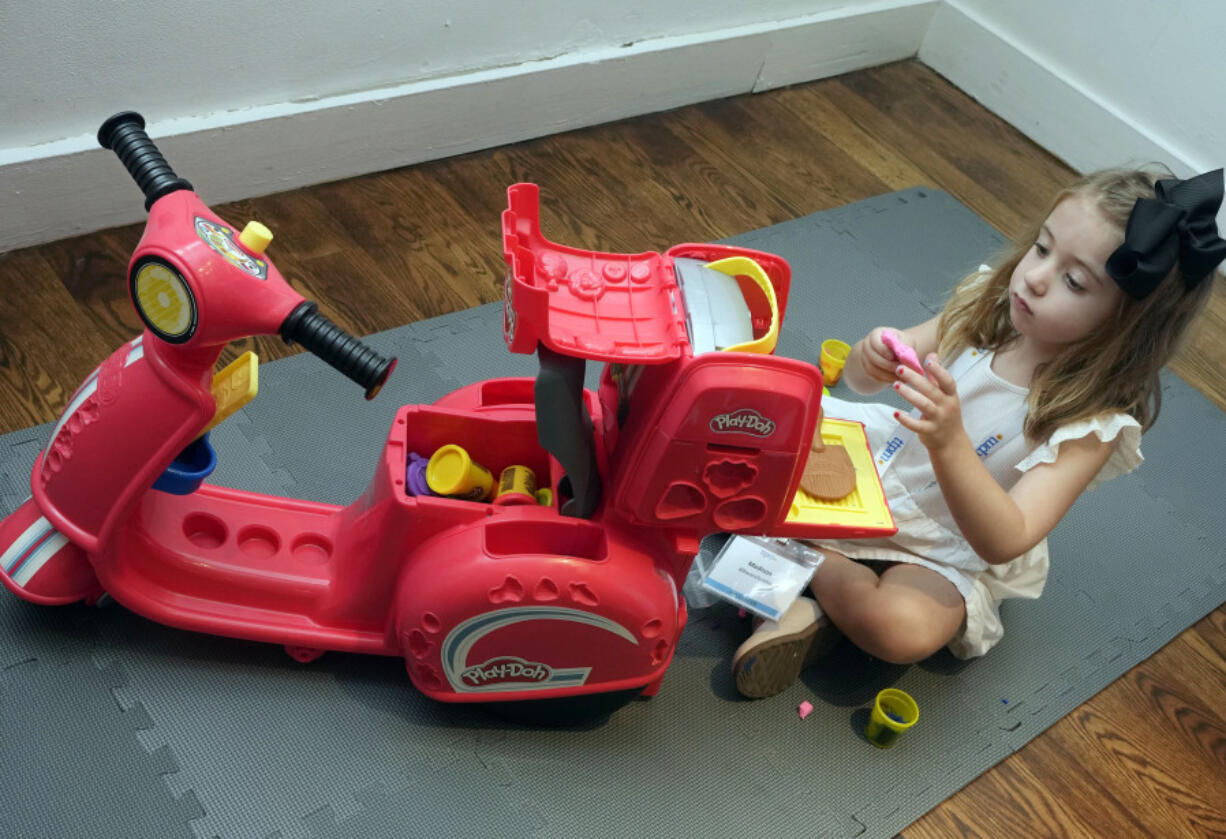 Madison Mangan, age 4 1/2, plays with a Play-Doh Pizza Scooter, from Hasbro, at the TTPM 2024 Holiday Showcase event, in New York, Tuesday, Sept. 17, 2024.