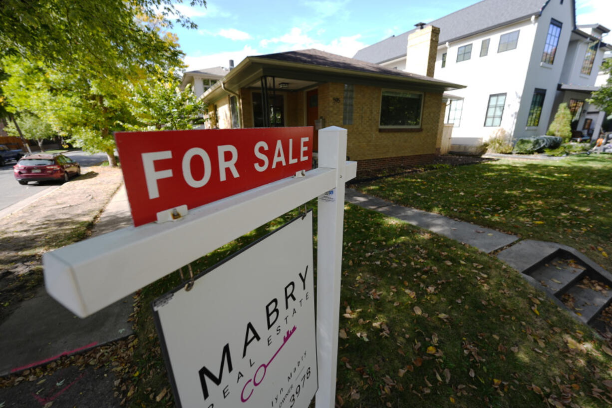 A sale sign stands outside a home on the market Thursday, Oct. 17, 2024, in the east Washington Park neighborhood of Denver.