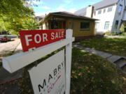 A sale sign stands outside a home on the market Thursday, Oct. 17, 2024, in the east Washington Park neighborhood of Denver.