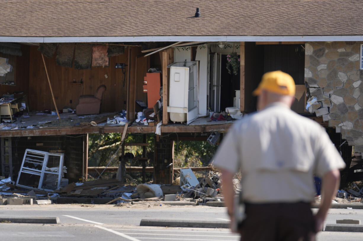 Paul Shaver looks a a building destroyed in the aftermath of Hurricane Helene Saturday, Oct. 5, 2024, in Newport, Tenn.