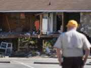 Paul Shaver looks a a building destroyed in the aftermath of Hurricane Helene Saturday, Oct. 5, 2024, in Newport, Tenn.