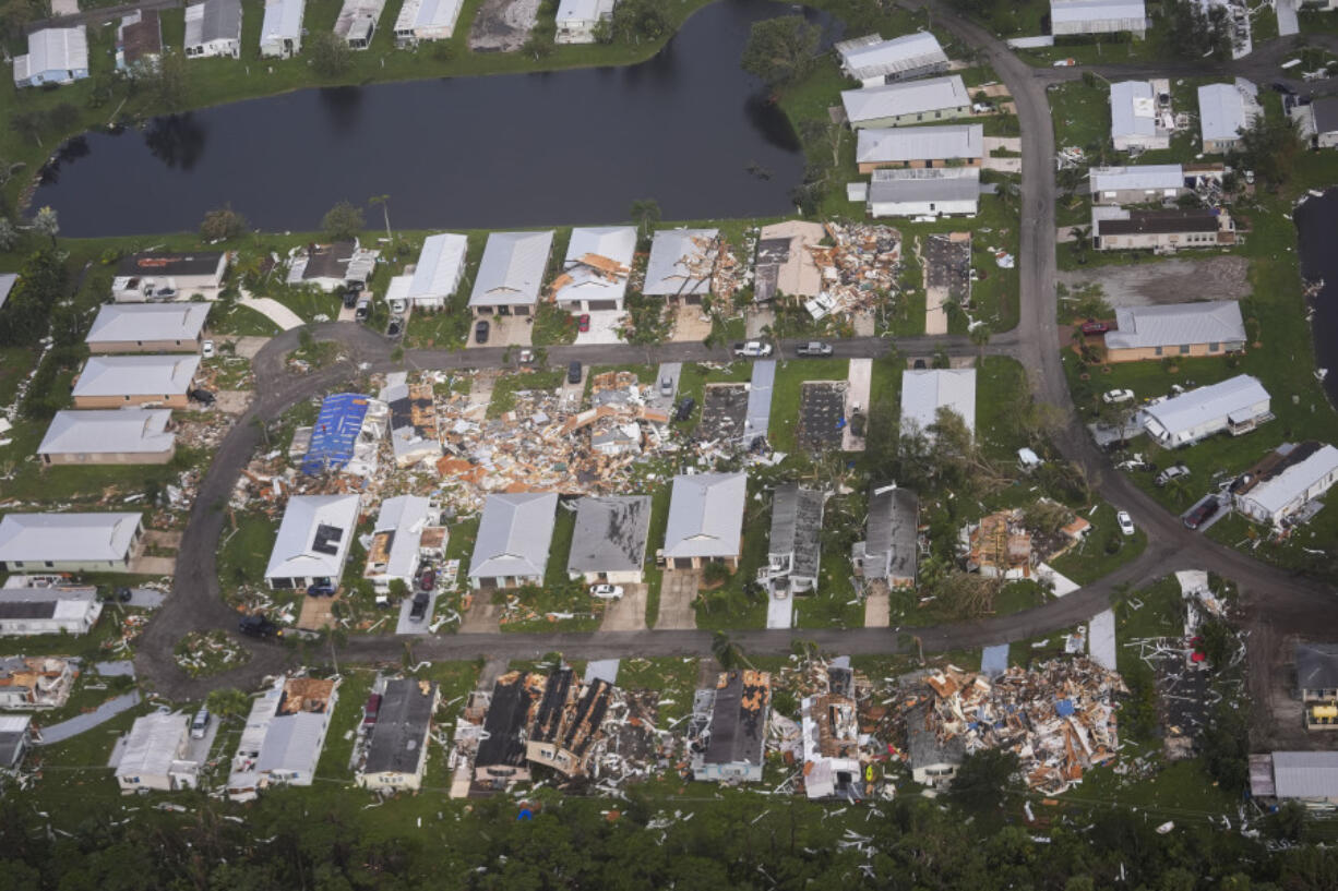 FILE - Neighborhoods with debris from tornadoes are visible in the aftermath of Hurricane Milton, Oct. 10, 2024, in Fort Pierce, Fla.