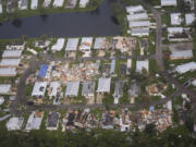 FILE - Neighborhoods with debris from tornadoes are visible in the aftermath of Hurricane Milton, Oct. 10, 2024, in Fort Pierce, Fla.