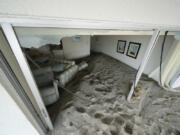 Several feet of sand fills a condo following the passage of Hurricane Milton, at YCA Vacation Rentals in Venice, Fla., Friday, Oct. 11, 2024.