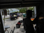 Mechanic Evan Purcell, 43, right, and friend Ted Carlson pack up tools and last-minute items they want to salvage from Purcell&rsquo;s duplex ahead of the arrival of Hurricane Milton, in Holmes Beach on Anna Maria Island, Fla., Tuesday, Oct. 8, 2024. Purcell, who has lived on the island for 40 years, suffered thousands of dollars in damage on his garage level from Hurricane Helene and says it&rsquo;s &ldquo;a coin toss&rdquo; whether his home will still be standing in a few days. &ldquo;I just have a pit in my stomach about this one,&rdquo; he said.