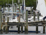 Owners try to secure their boat at the Davis Islands Yacht Clubs ahead a possible landfall by Hurricane Milton, Monday, Oct. 7, 2024, in Tampa, Fla.